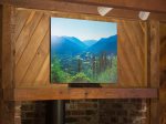 The picture of the Elwha Valley above the wood stove shows Hurricane Ridge in the background
